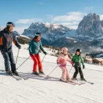 Una famiglia su una pista da sci approfitta di una settimana in una delle località sciistiche economiche